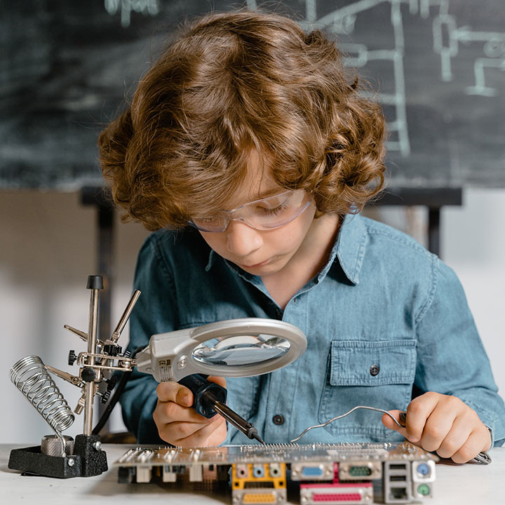 a boy performing soldering