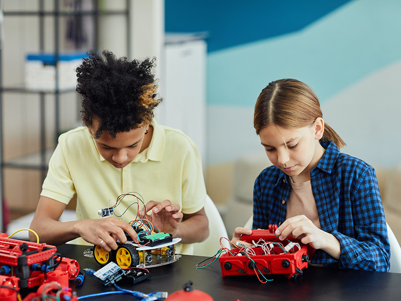 two kids building a robot